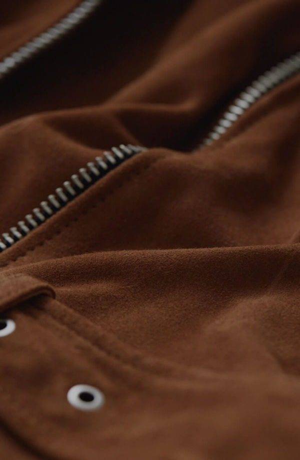 Zoom the zip of a leather jacket.