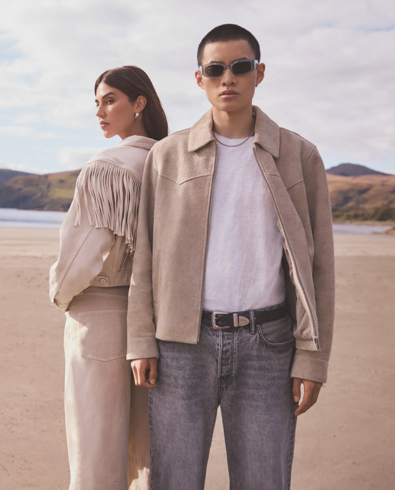 A man and woman standing on a beach