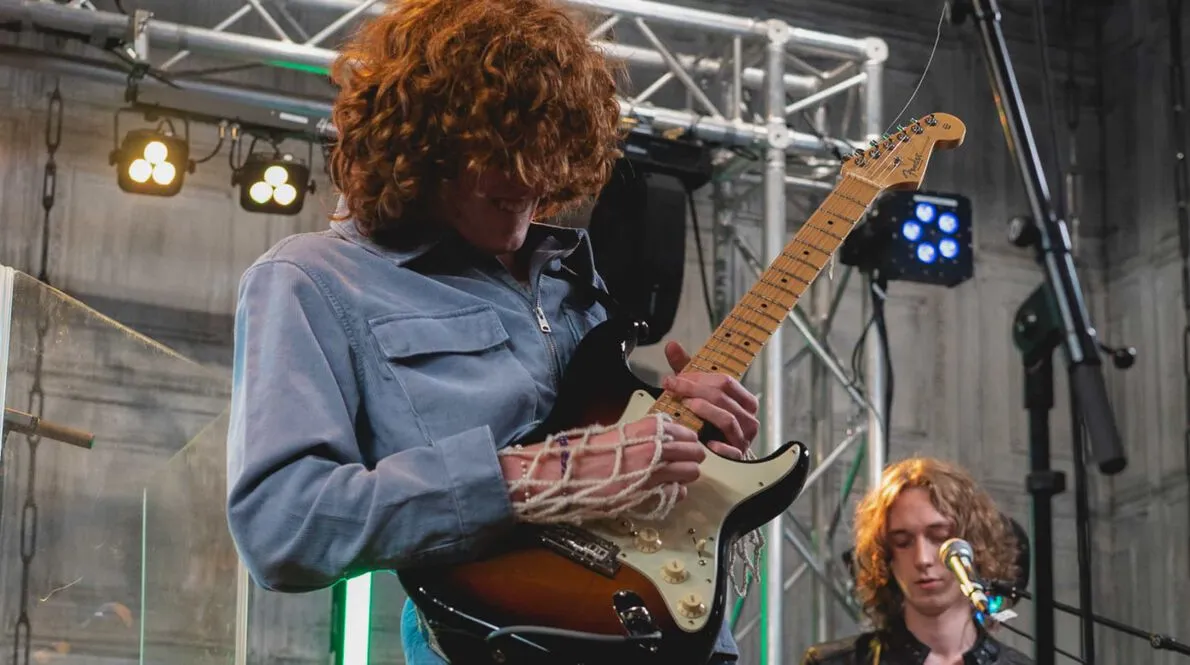 The Sukis band member playing the guitar