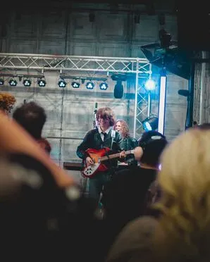 The Sukis band member playing in front of the audience