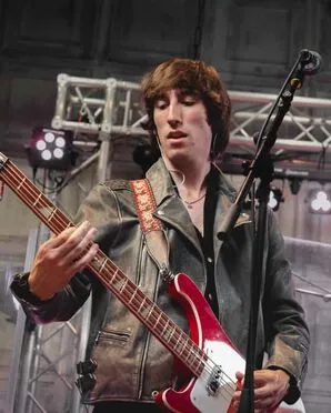 The Suki band member playing the guitar