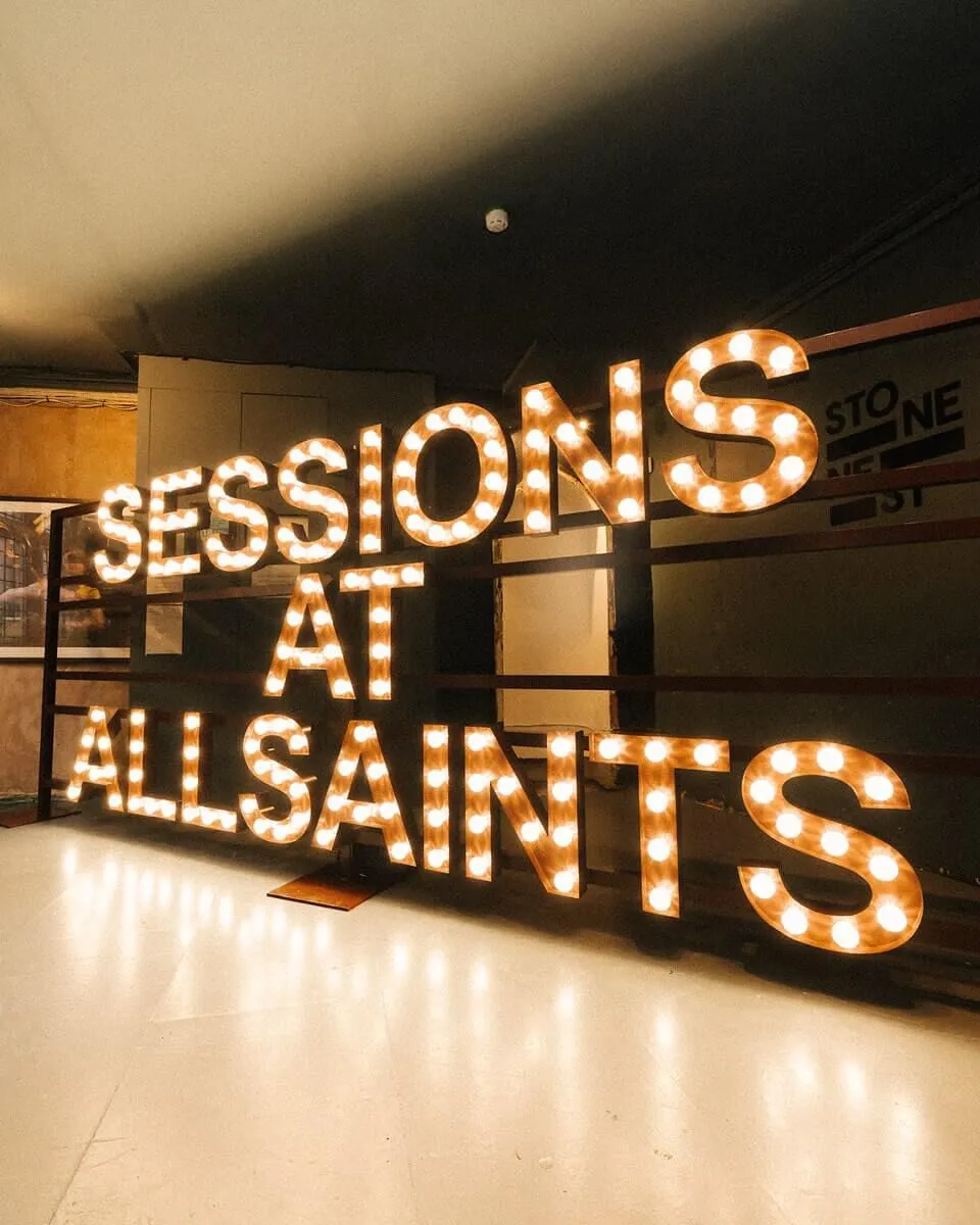 Neon reading SESSIONS AT ALLSAINTS