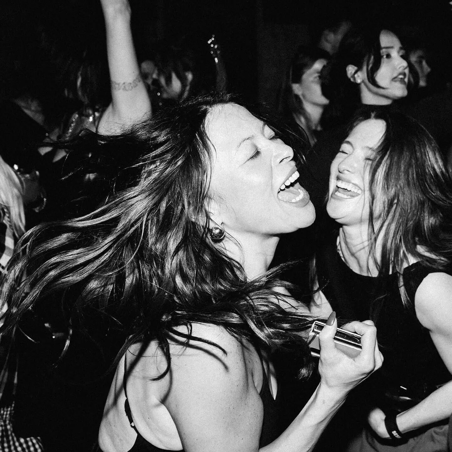 Black and white photograph showing dancing audience