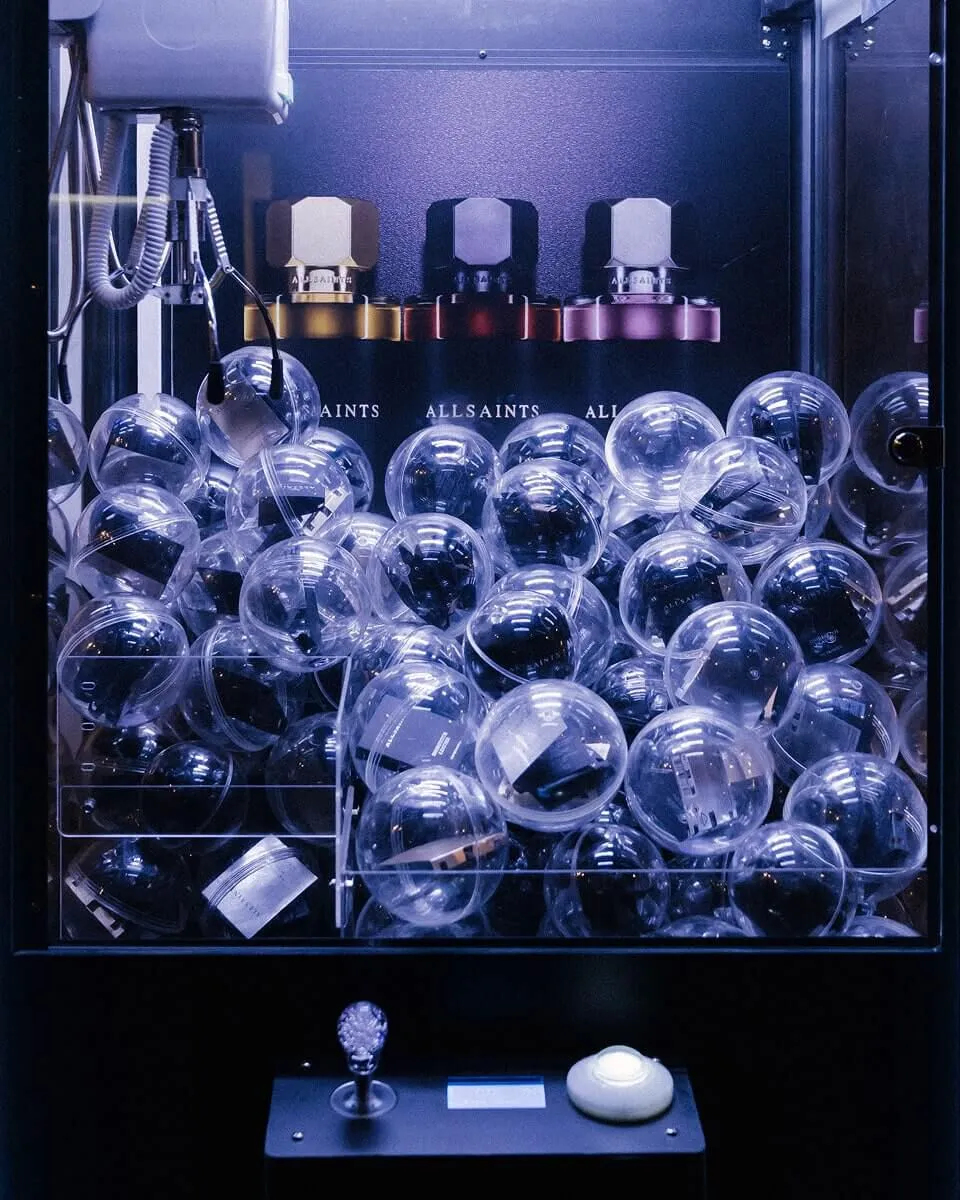 A vending machine showing AllSaints perfume