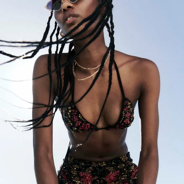 A woman wearing a sequin bikini top and sequin bottoms.