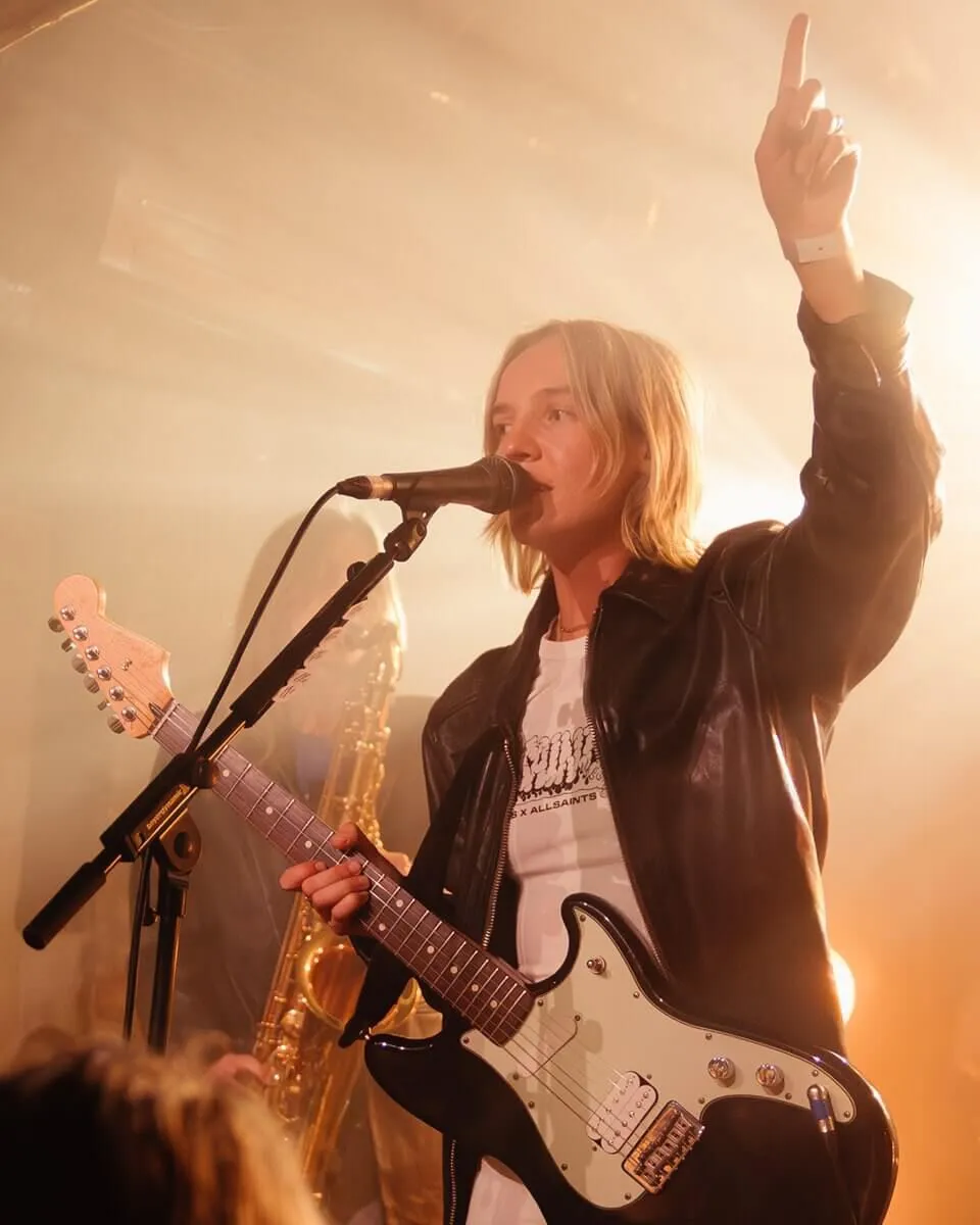 Black and white shot of STORRY on stage performing.