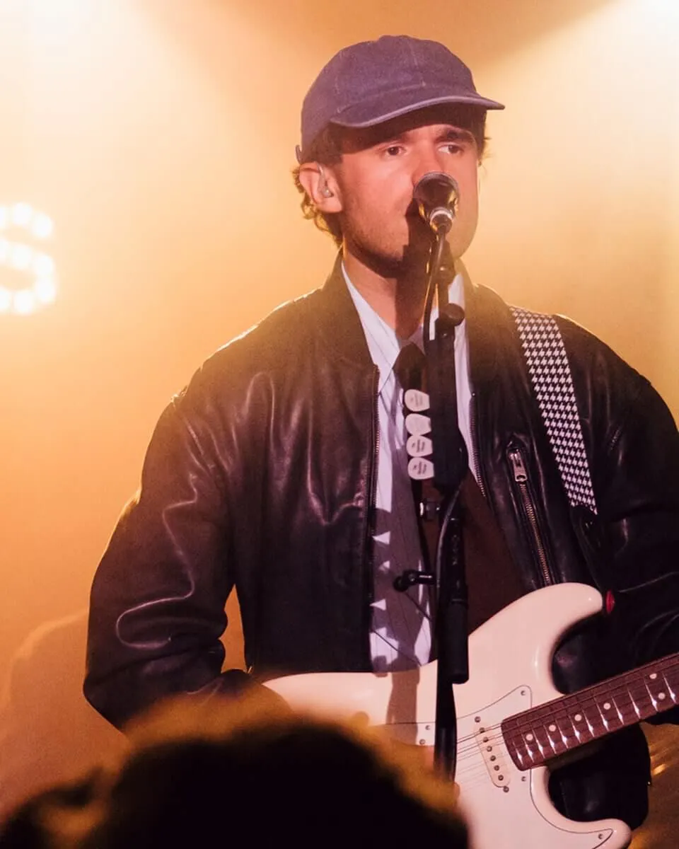 Full length shot of FLAT MOON posing infront of a wall.