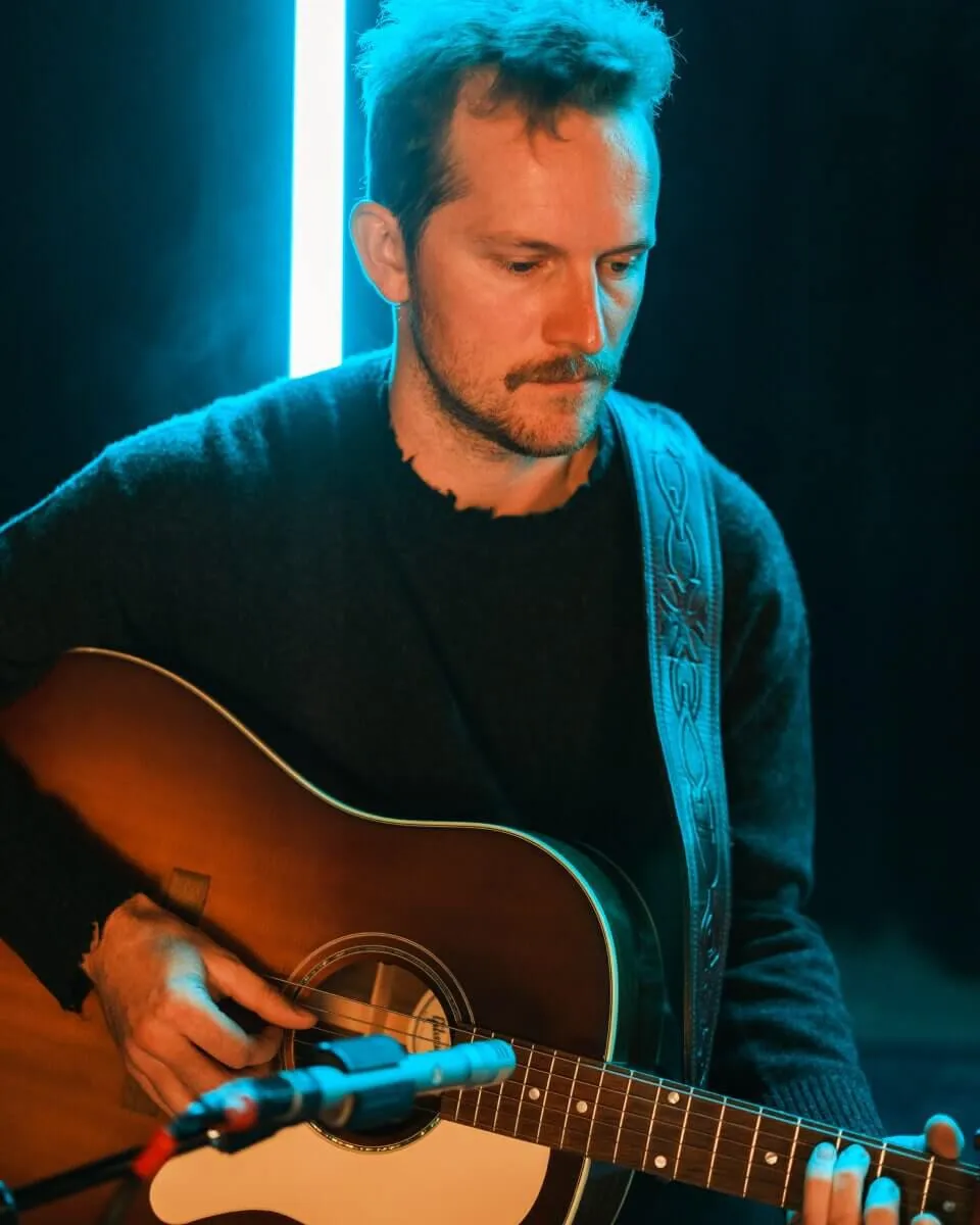 A man playing the guitar.