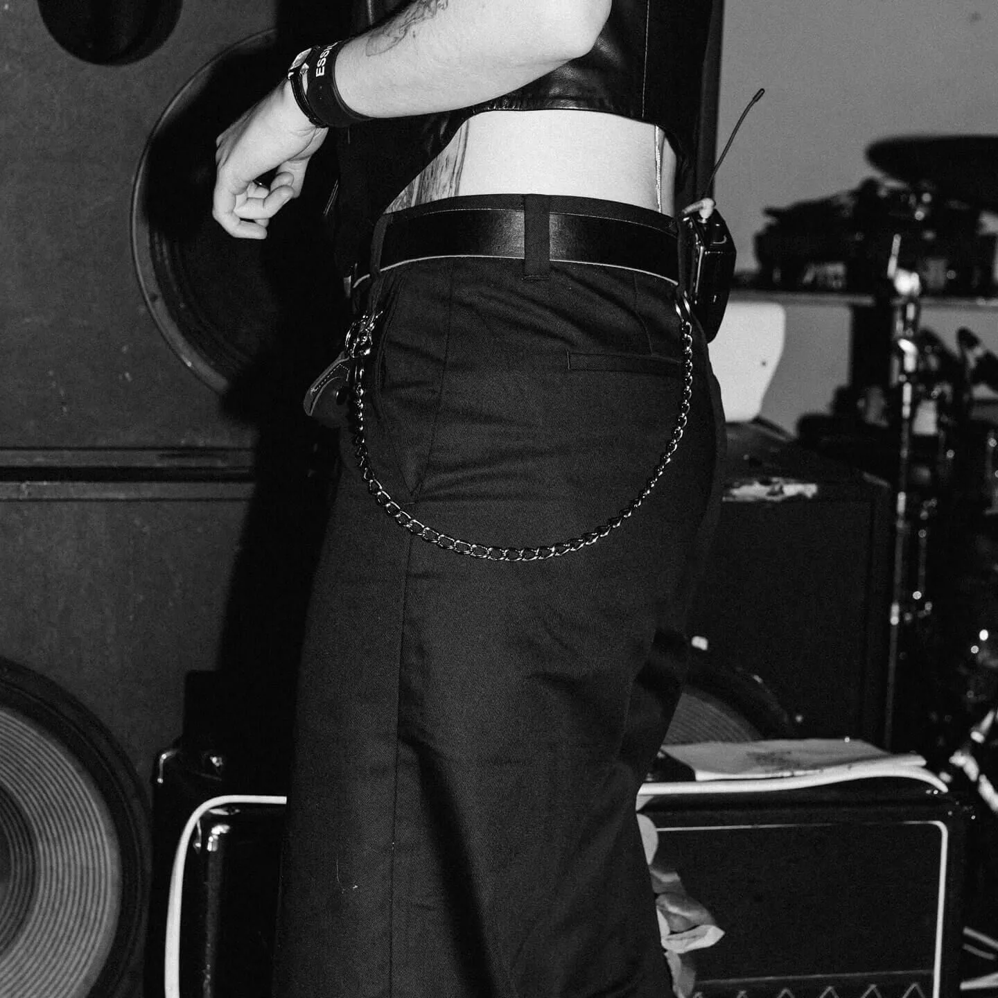 Black and white closeup shot of a crew members lower body, wearing jeans and a t-shirt.
