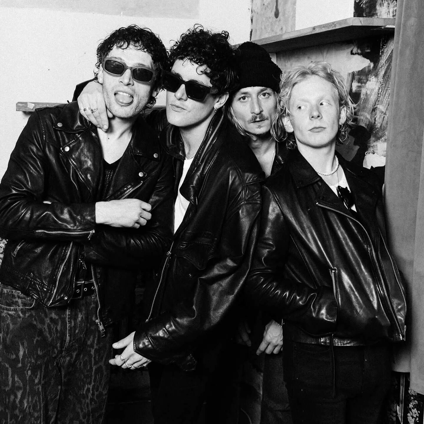 Black and white photograph showing LEAP wearing leather jackets