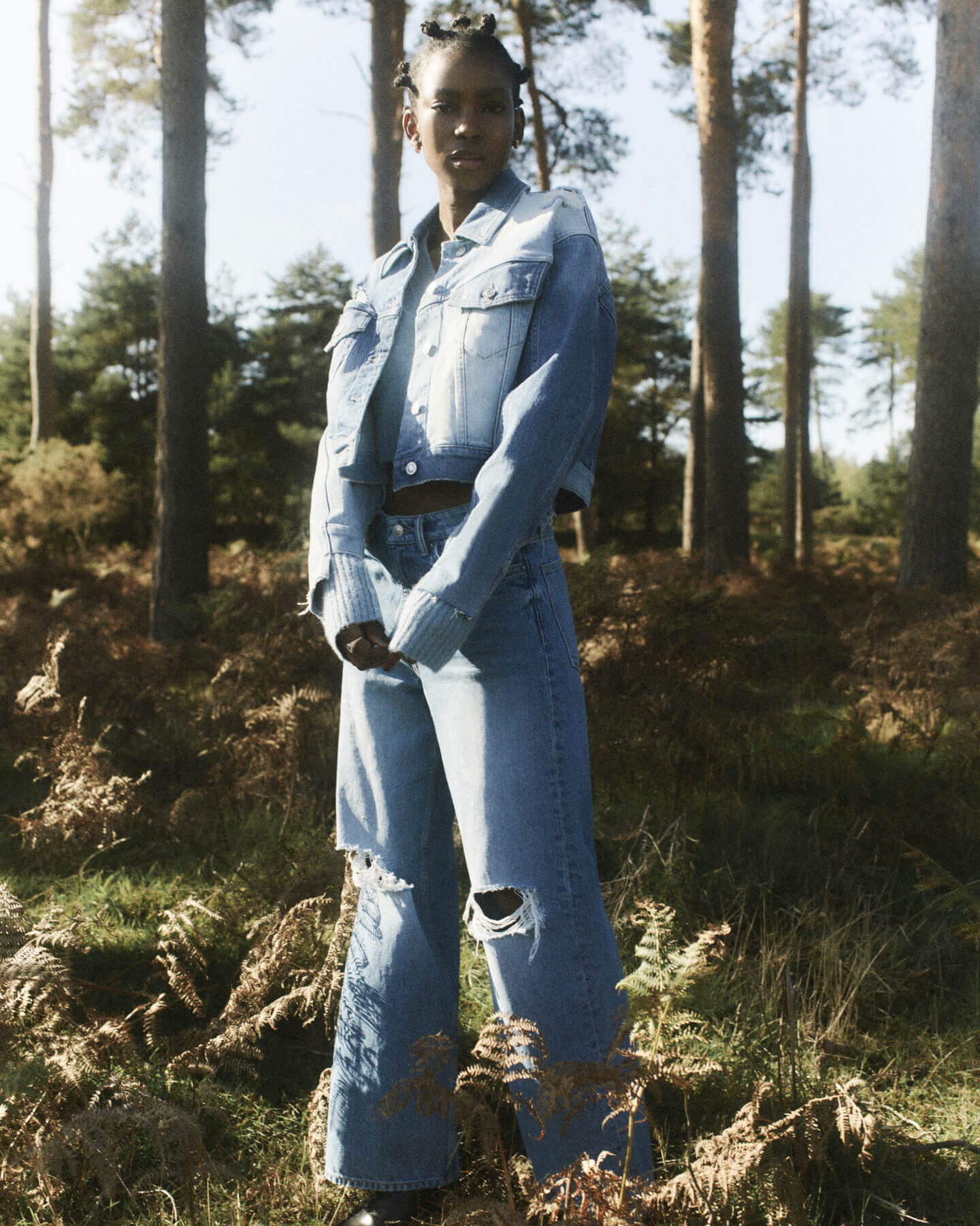Woman wearing a denim jacket and jeans on heathland