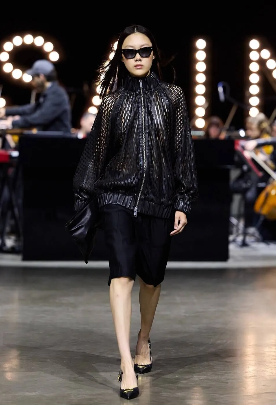 Woman wearing a black skirt with a black leather jacket