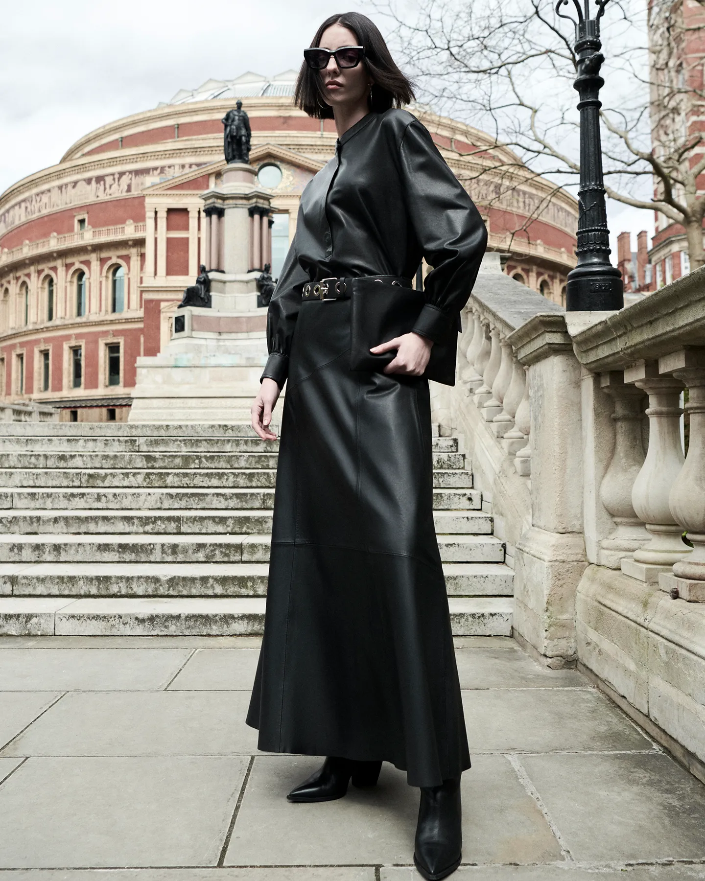 A woman wearing a black leather dress.