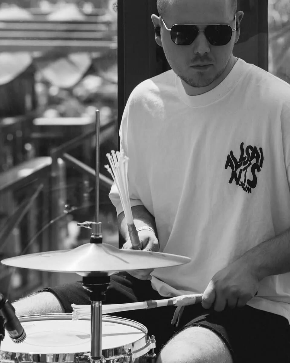 Black and white closeup of the drummer performing.