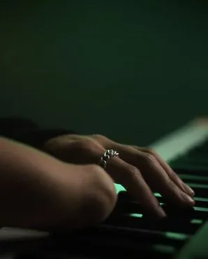 A close-up image of Victoria Canal playing the keyboard