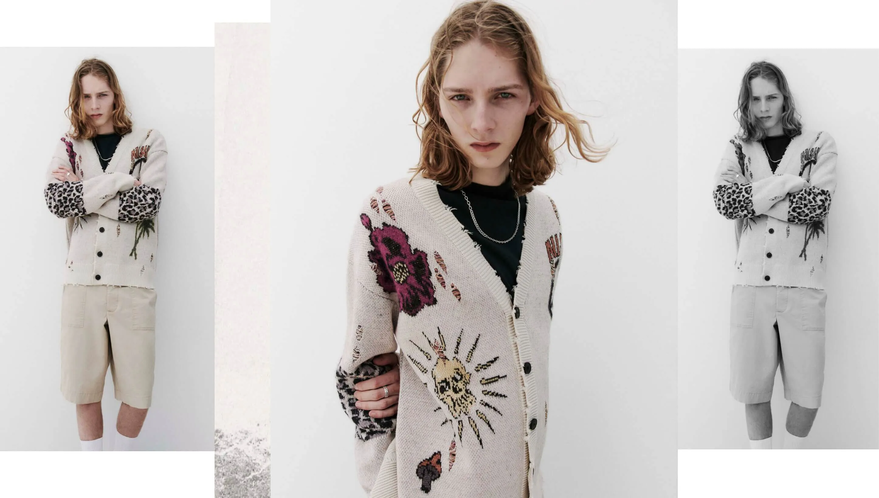 A collage of three photographs showing a man wearing a v neck cardigan with frayed details and artworks over a black t-shirt, and bermuda shorts standing in front of a beige wall.