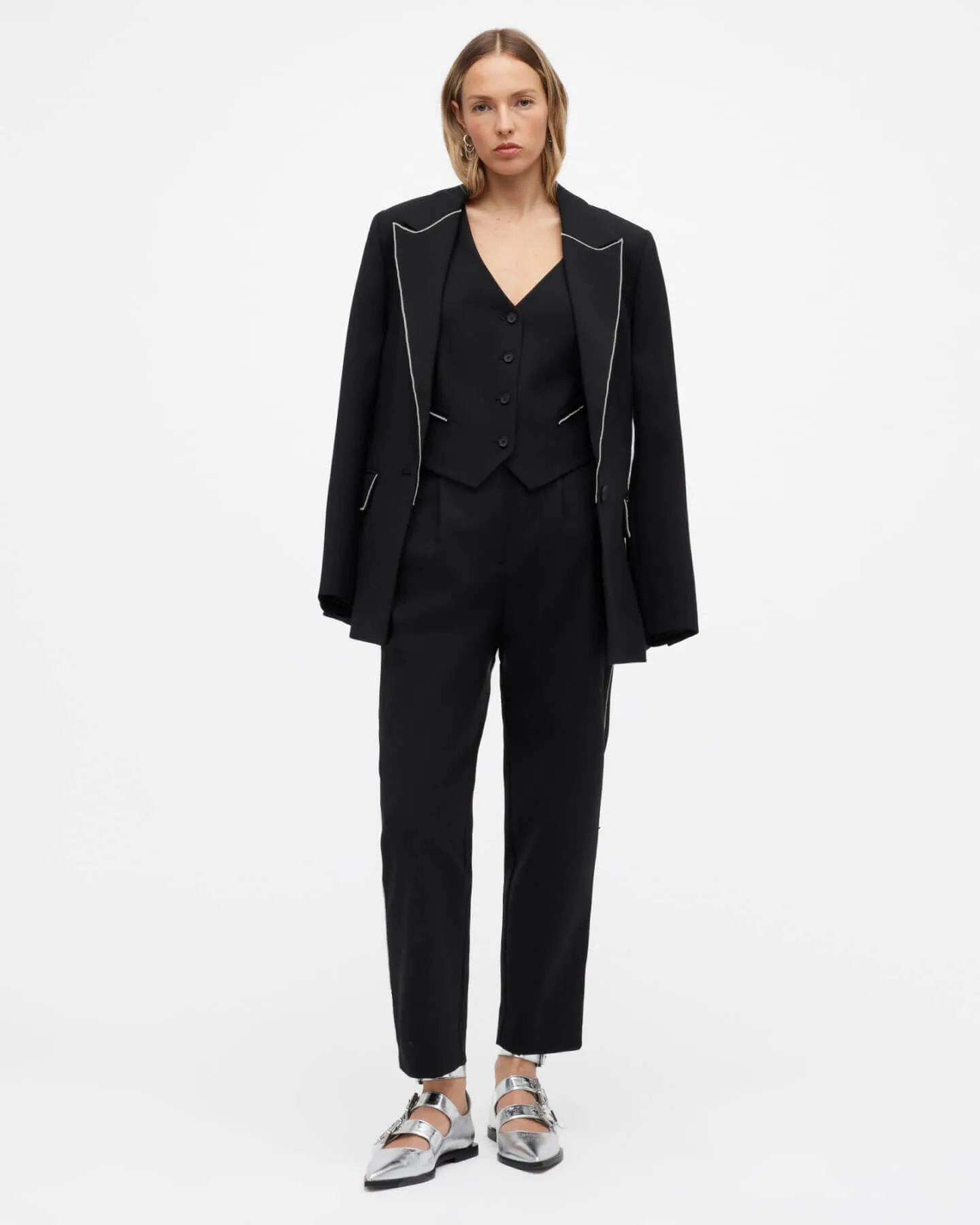 A woman wearing a black suit.